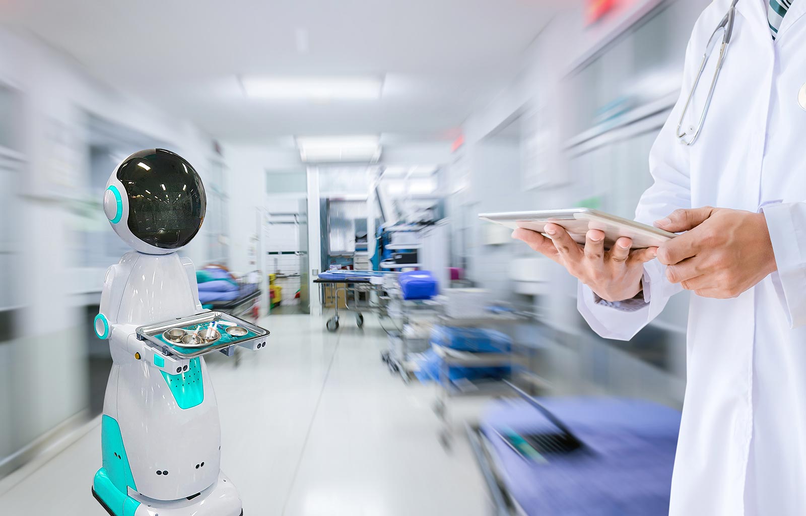 A simple delivery robot moves medical equipment on a tray through a busy hospital corridor..